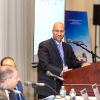 Shimon Shkury, shares a light moment with panelists at Coffee & Cap Rates