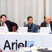 Panelists engage in a discussion moderated by Shimon Shkury at Coffee & Cap Rates, February 4, 2016