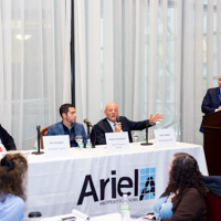 Panelists engage in a discussion moderated by Shimon Shkury at Coffee & Cap Rates, February 4, 2016